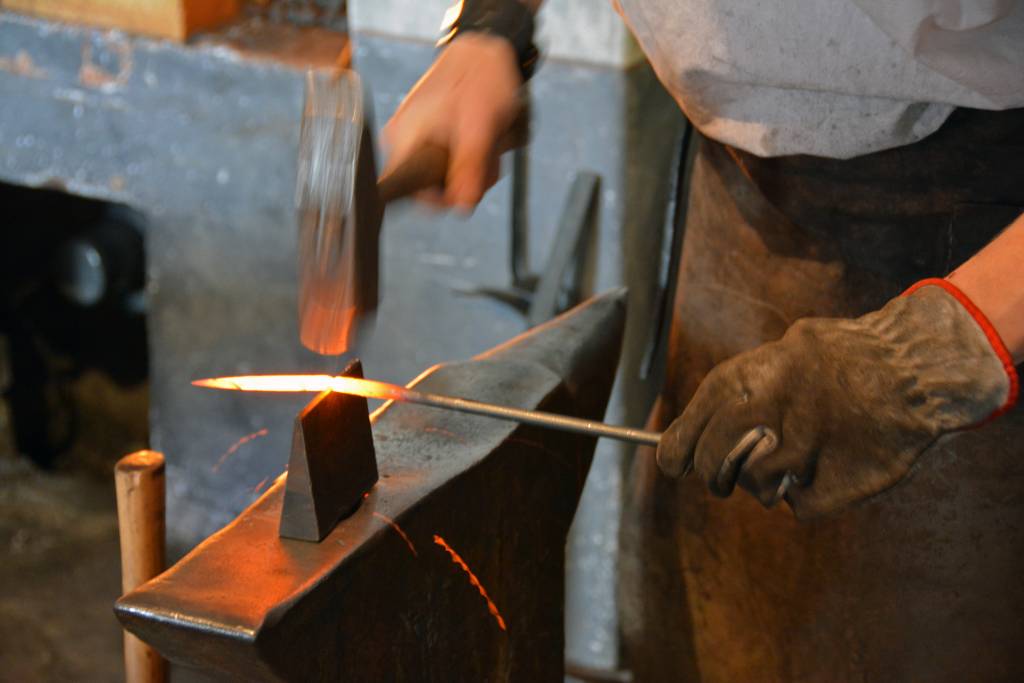 Blacksmith shaping metal